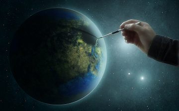 El planeta Tierra y una mano con un pincel pintando sobre él